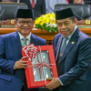 Ranperda RPPLH, Pembangunan Berpihak pada Kelestarian Hidup March 2, 2026 1:12 pm DPRD DKI Jakarta mendengarkan penyampaian pidato Gubernur DKI Jakarta terhadap Rancangan Peraturan Daerah (Ranperda) tentang Rencana Perlindungan dan Pengelolaan Lingkungan Hidup (RPPLH) dalam Rapat Paripurna. Penyampaian pidato tersebut merupakan bagian dari tahapan pembahasan Ranperda RPPLH yang menjadi pedoman perlindungan dan pengelolaan lingkungan hidup di tingkat Provinsi DKI Jakarta. Gubernur DKI Jakarta Pramono Anung Wibowo menjelaskan, penyusunan RPPLH merupakan kewajiban pemerintah daerah sebagaimana diamanatkan dalam peraturan perundang-undangan. “RPPLH disusun sebagai dokumen perencanaan jangka panjang selama 30 tahun yang menjadi pedoman dalam perlindungan dan pengelolaan lingkungan hidup,” ujar Pram, Senin (2/3). Lebih lanjut disampaikan, dokumen RPPLH menjadi landasan integrasi kebijakan pembangunan dan penataan ruang agar setiap proses pembangunan tetap berpihak pada kelestarian lingkungan hidup. “Dokumen ini memastikan setiap proses pembangunan berpihak pada kelestarian lingkungan,” kata Pram. Dalam Ranperda tersebut juga ditetapkan visi RPPLH Provinsi DKI Jakarta, yakni lingkungan hidup yang aman, sehat, dan serkelanjutan menuju Kota Global untuk semua. Maka, untuk mewujudkan visi tersebut, RPPLH menetapkan tiga sasaran utama, yaitu peningkatan mutu lingkungan hidup, penguatan komponen daya dukung dan daya tampung lingkungan hidup, serta peningkatan kelimpahan aset keanekaragaman hayati. “Dalam penyusunan RPPLH telah ditetapkan skenario optimis sebagai sasaran akhir hingga 30 tahun ke depan,” ucap Pram. Skenario tersebut dipilih sebagai bentuk komitmen kuat dalam mendukung transformasi Jakarta menjadi Kota Global yang berkelanjutan dan memiliki ketahanan lingkungan yang tinggi melalui tahapan pembangunan yang progresif. Menutup penyampaiannya, ia berharap agar Ranperda RPPLH dapat dibahas secara komprehensif oleh DPRD. “Eksekutif berharap, penjelasan ini dapat membantu pembahasan pada rapat Fraksi dan Komisi, sehingga dewan dapat mempertimbangkan dengan seksama Ranperda dimaksud dan dapat disetujui menjadi Perda,” tutur Pram. Di kesempatan itu, Ketua DPRD DKI Jakarta Khoirudin menyatakan, DPRD melalui sembilan fraksi akan segera mendalami dan mencermati penjelasan gubernur. Kemudian, merangkumnya menjadi bahan pandangan umum fraksi-fraksi. “Insyaallah, hasilnya akan disampaikan dalam Rapat Paripurna DPRD pada hari Senin 9 Maret 2026 Pukul 10.00 WIB,” tandas Khoirudin. (gie/df)